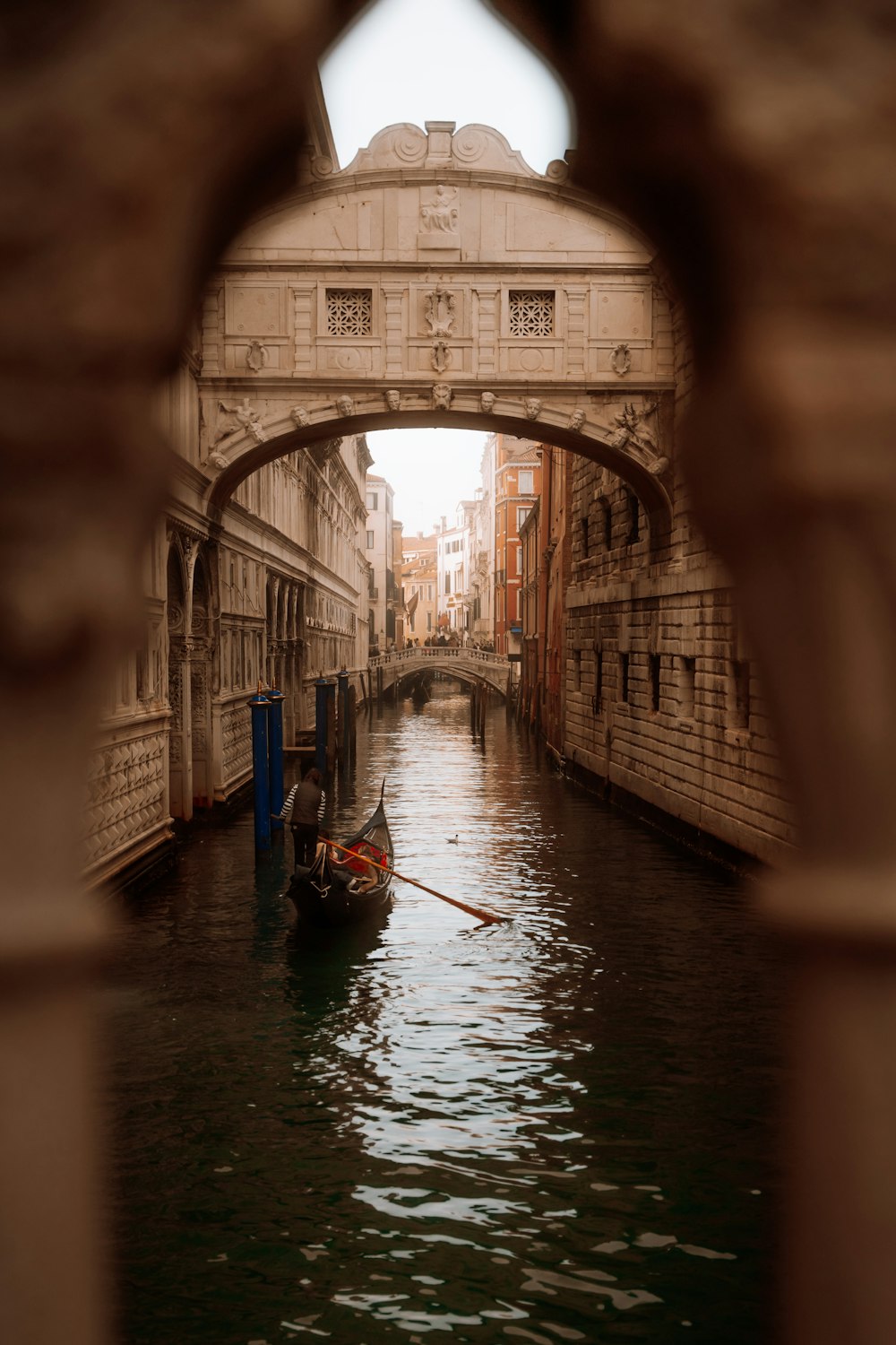 a small boat is going under a bridge