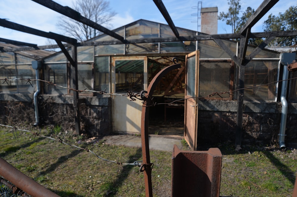 a run down building with a metal fence around it