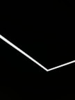 A minimalist design featuring a single white angular line traversing a black background, creating a stark contrast and geometric aesthetic.