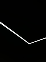 Minimalist black background with subtle white architectural lines suggesting upward growth.