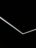 A minimalist design featuring a single white angular line traversing a black background, creating a stark contrast and geometric aesthetic.