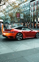 a red sports car parked on the side of the road