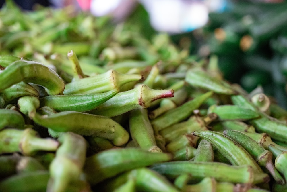 a pile of green beans sitting on top of a table