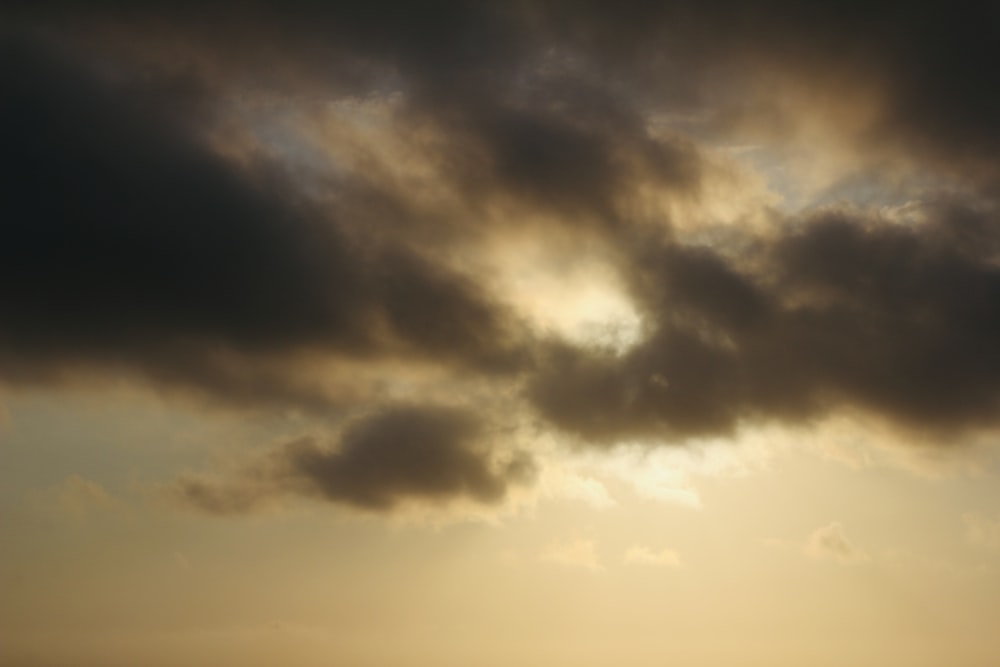 the sun is shining through the clouds over the ocean