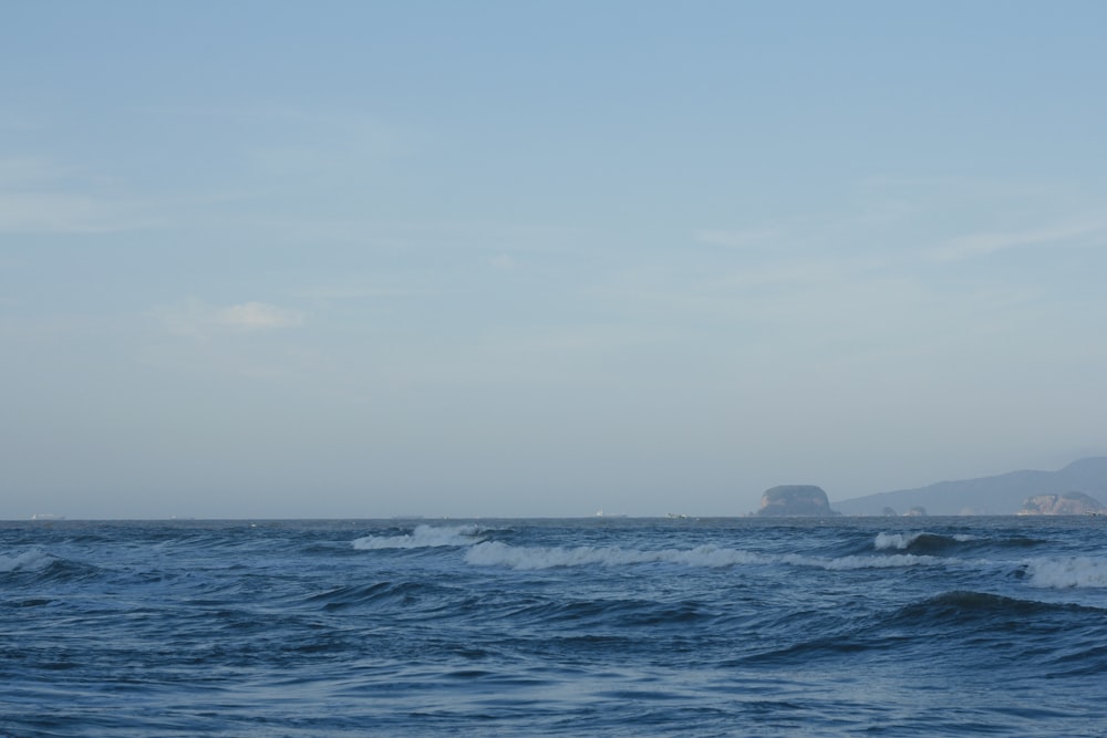 a large body of water with a small island in the distance