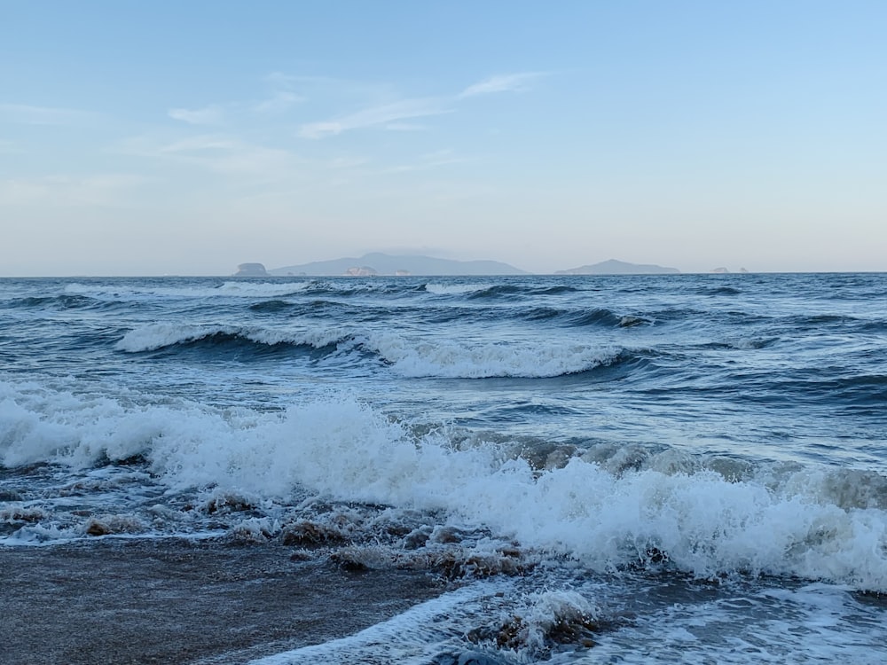 a body of water with waves coming in to shore