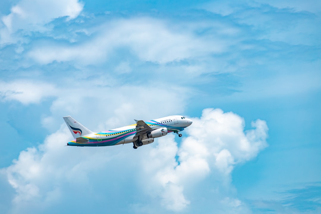 an airplane is flying through the blue sky, Bangkok Air