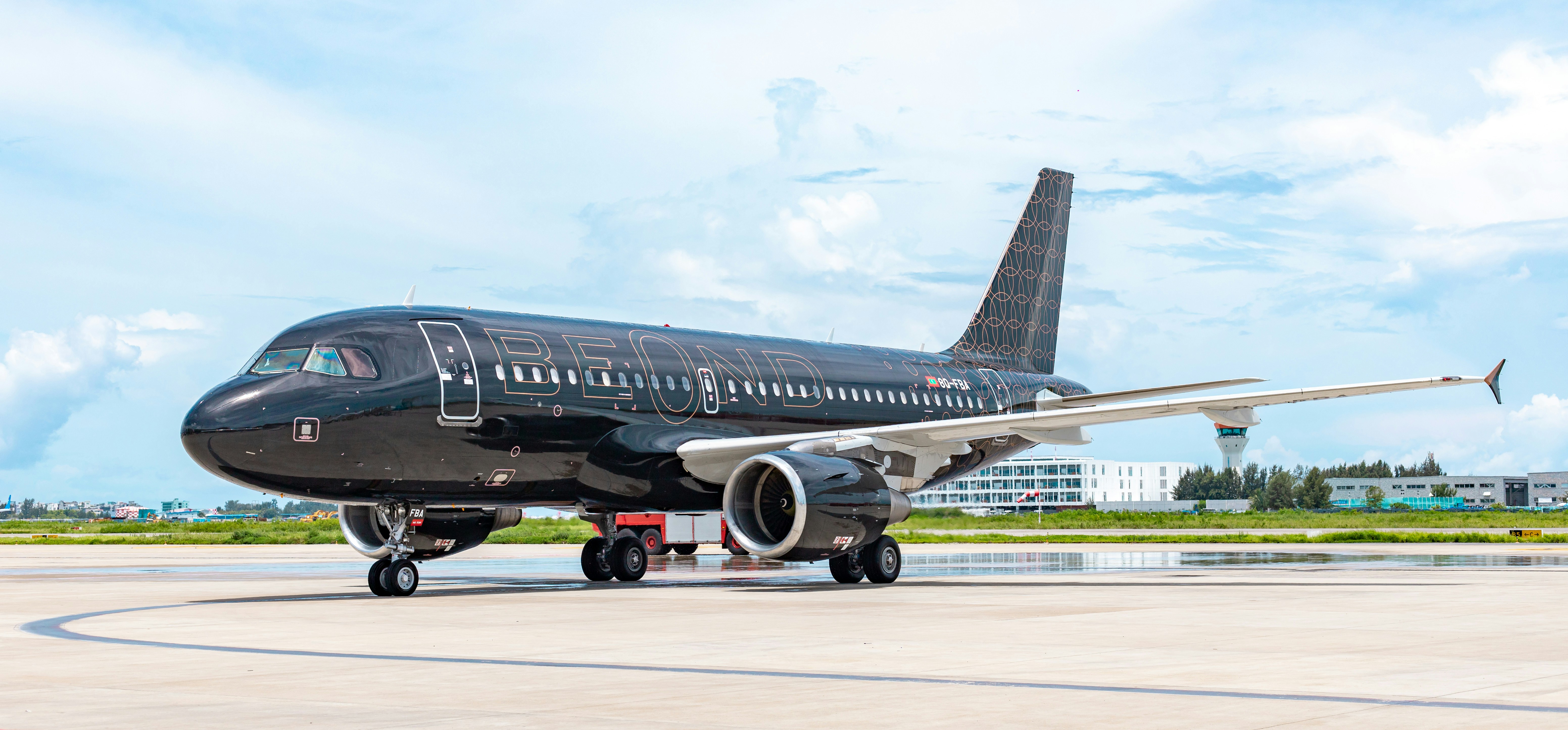 a large jetliner sitting on top of an airport tarmac, Beond Airline Livery