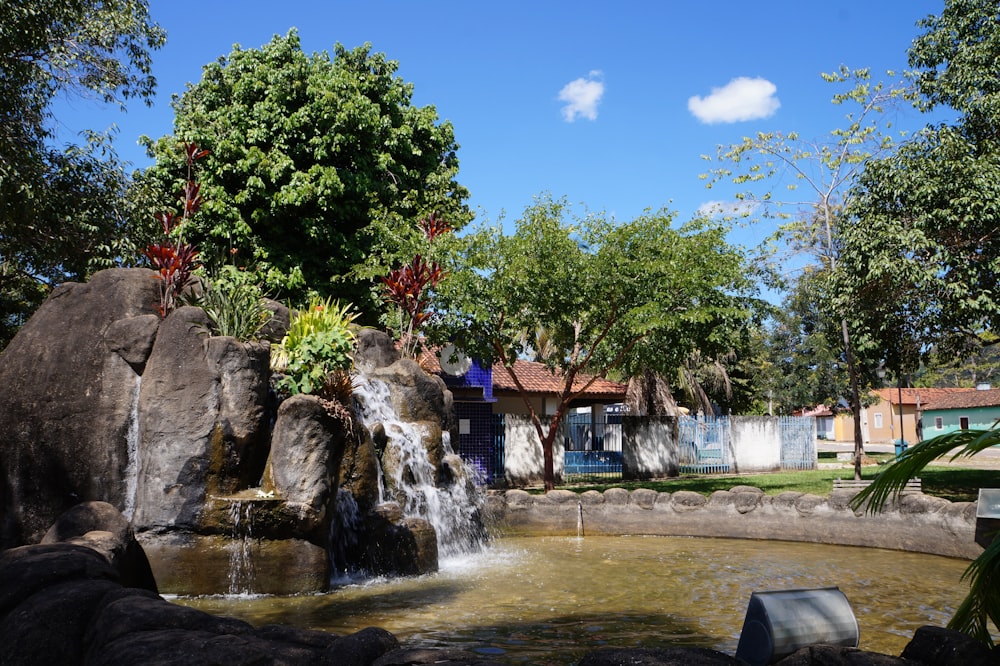 a small waterfall in the middle of a park