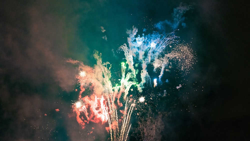 a colorful fireworks is lit up in the night sky