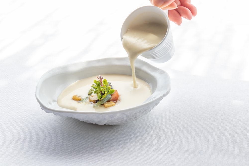 a bowl of soup being poured into it