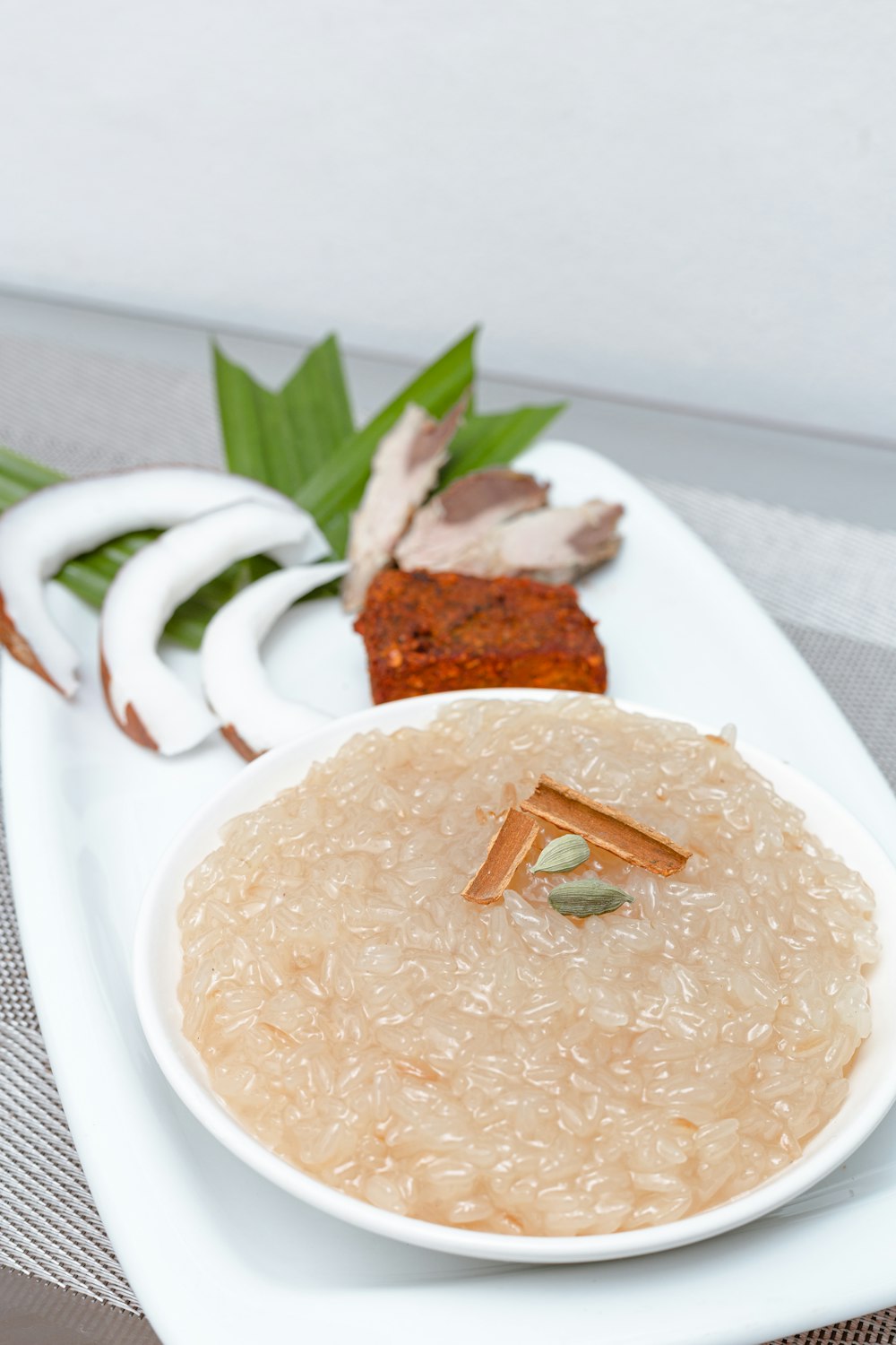 a white plate topped with a bowl of food