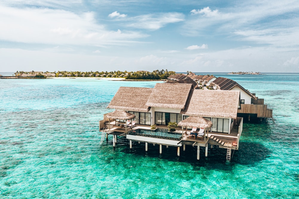 a couple of houses sitting on top of a body of water