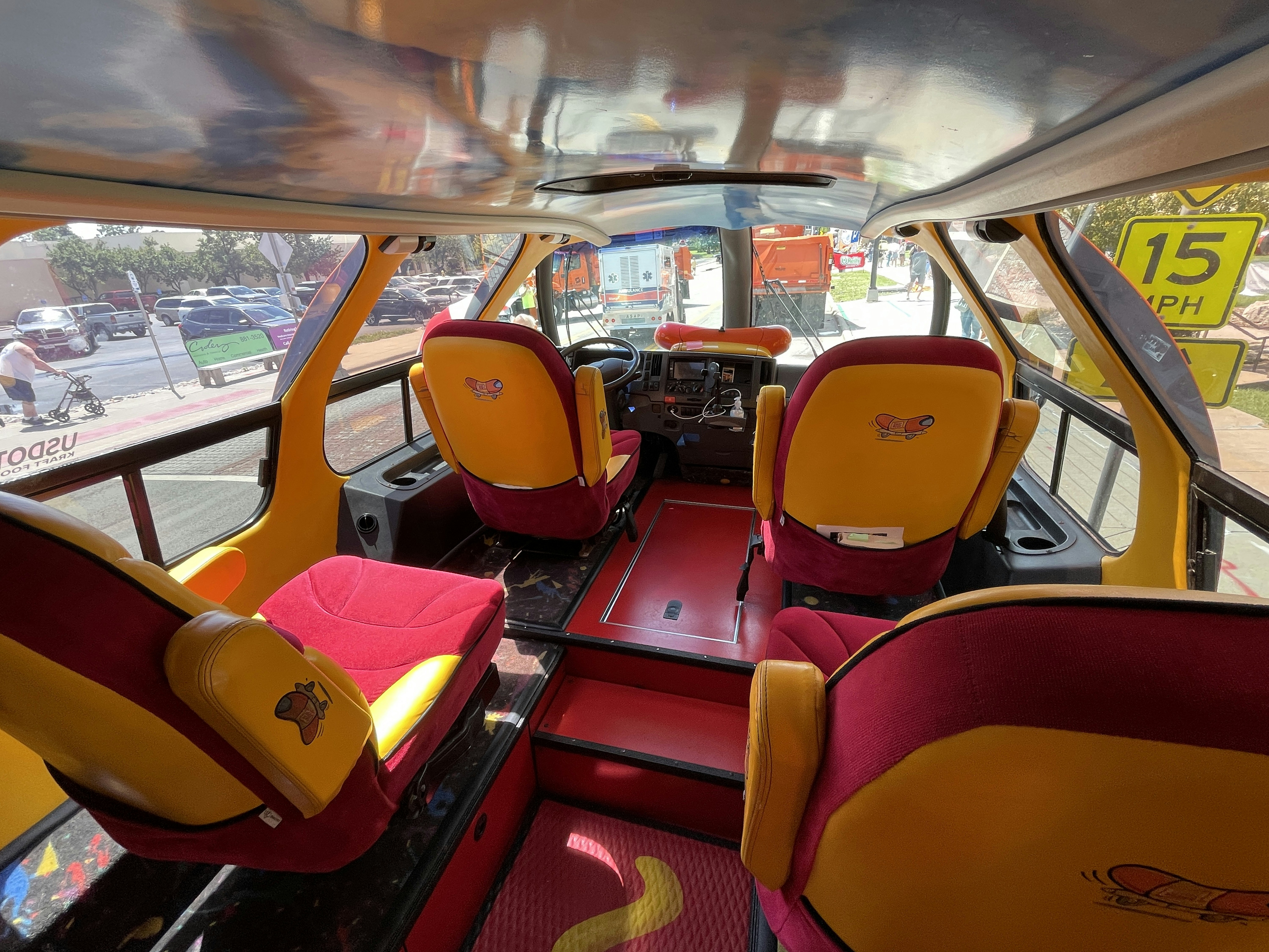 the interior of a bus with red and yellow seats