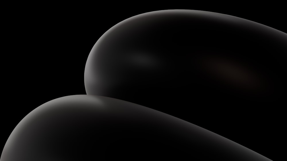 un fond noir avec un objet noir au milieu