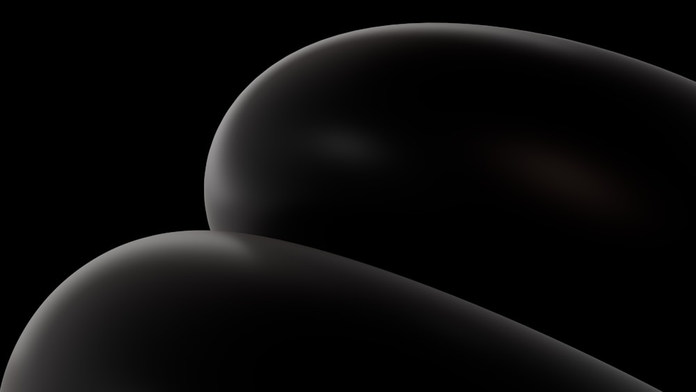 a black background with a black object in the middle