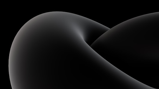 Minimalist abstract patterns with faint particle depth over a deep black and graphite gradient.