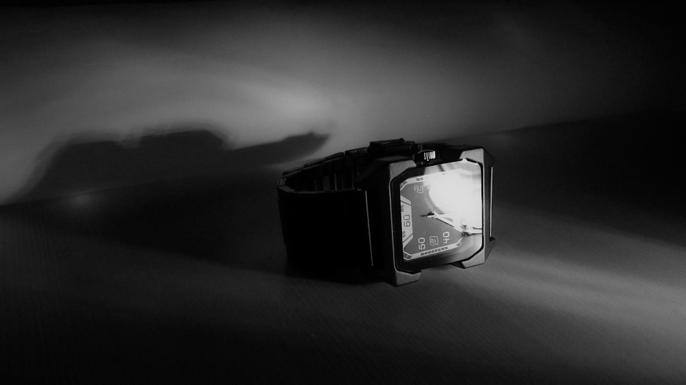 a black and white photo of a wrist watch