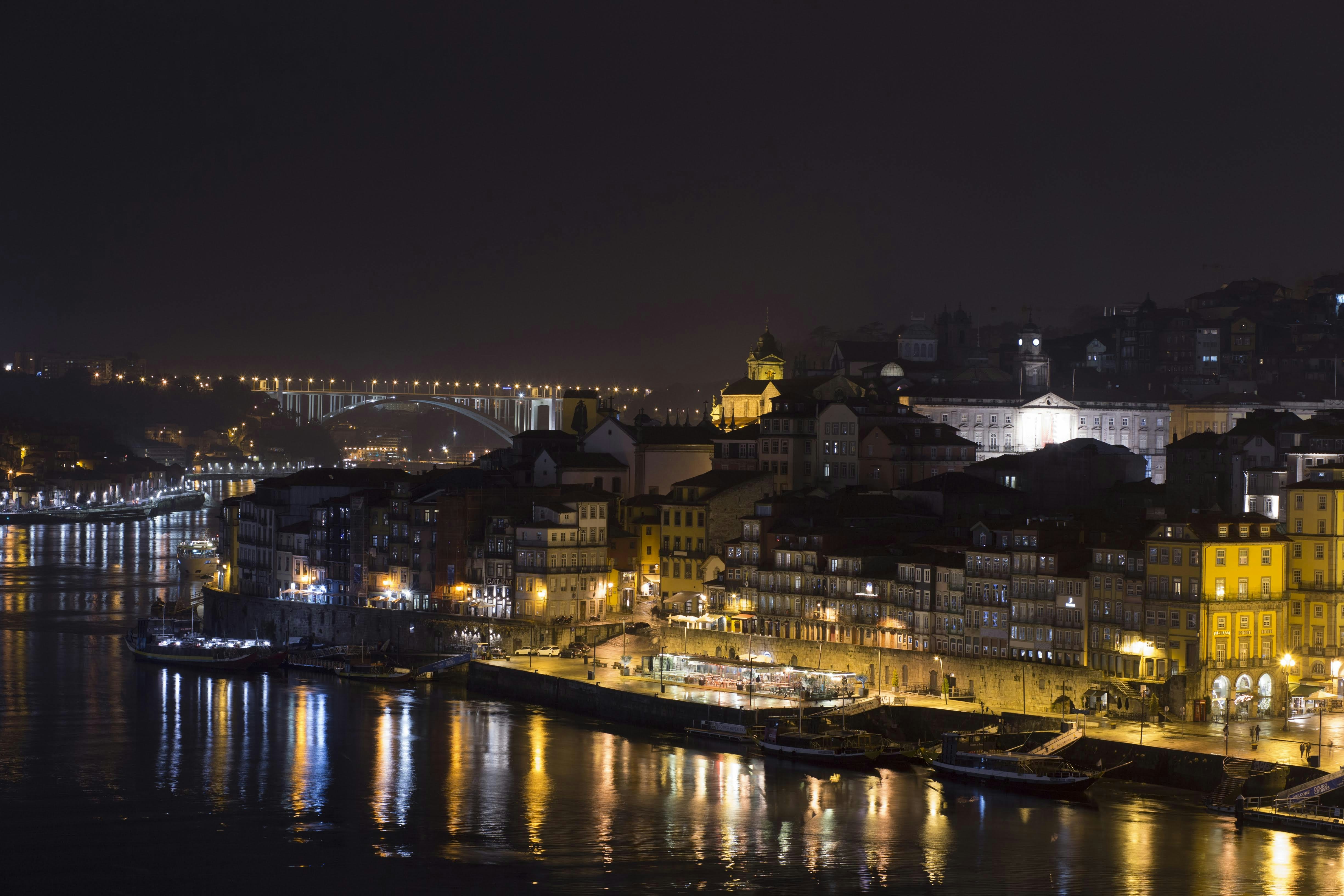 a night view of a city with a bridge in the background