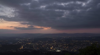 A cloud server icon overlaying a digital cityscape at dusk.