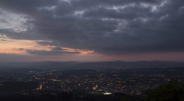 A cloud server icon overlaying a digital cityscape at dusk.