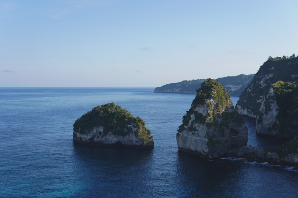 a group of rocks in the middle of a body of water