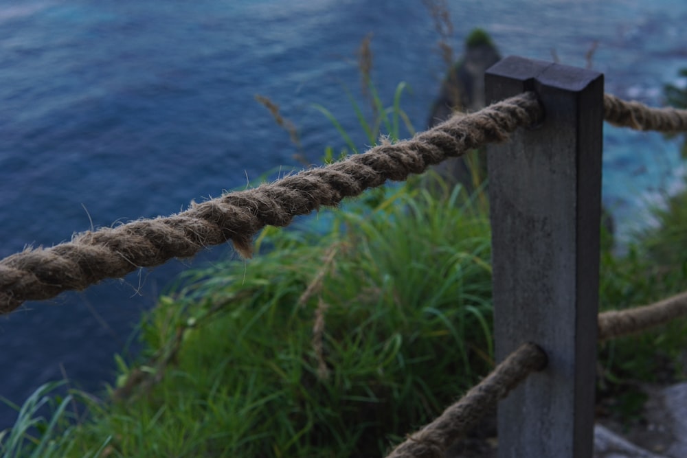 a close up of a rope attached to a wooden post