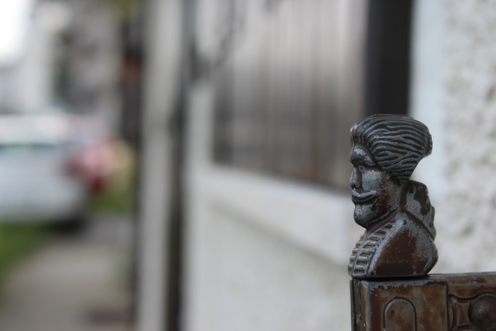 a close up of a statue of a man on the side of a building