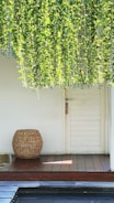 A cozy balcony door with a minimalist insect screen blending with green plants outside.