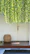 A rustic bench stool placed by a front door with a woven decorative basket underneath.