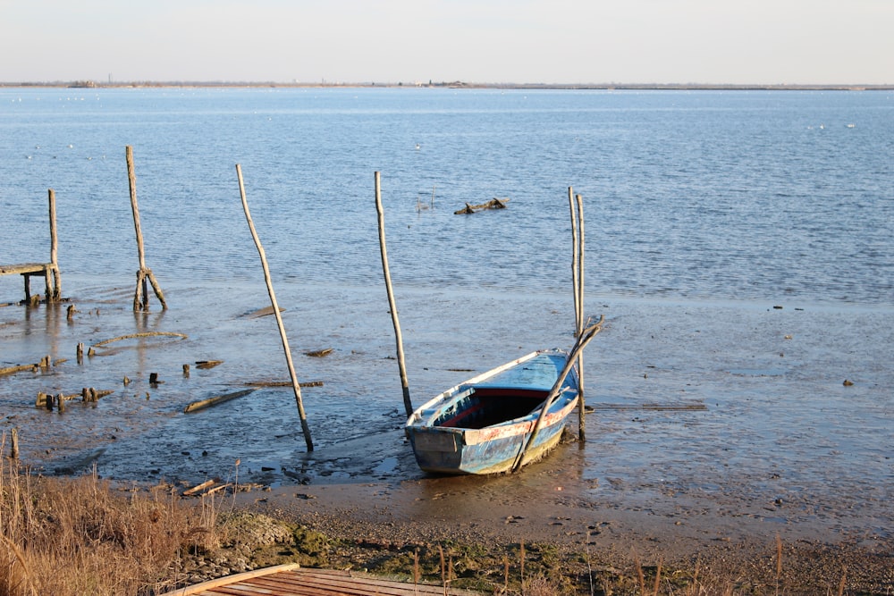 a small boat sitting on top of a body of water