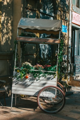 The Nomad Nosh cart decorated with seasonal flowers and rustic wooden accents, ready for a Pennsylvania event.