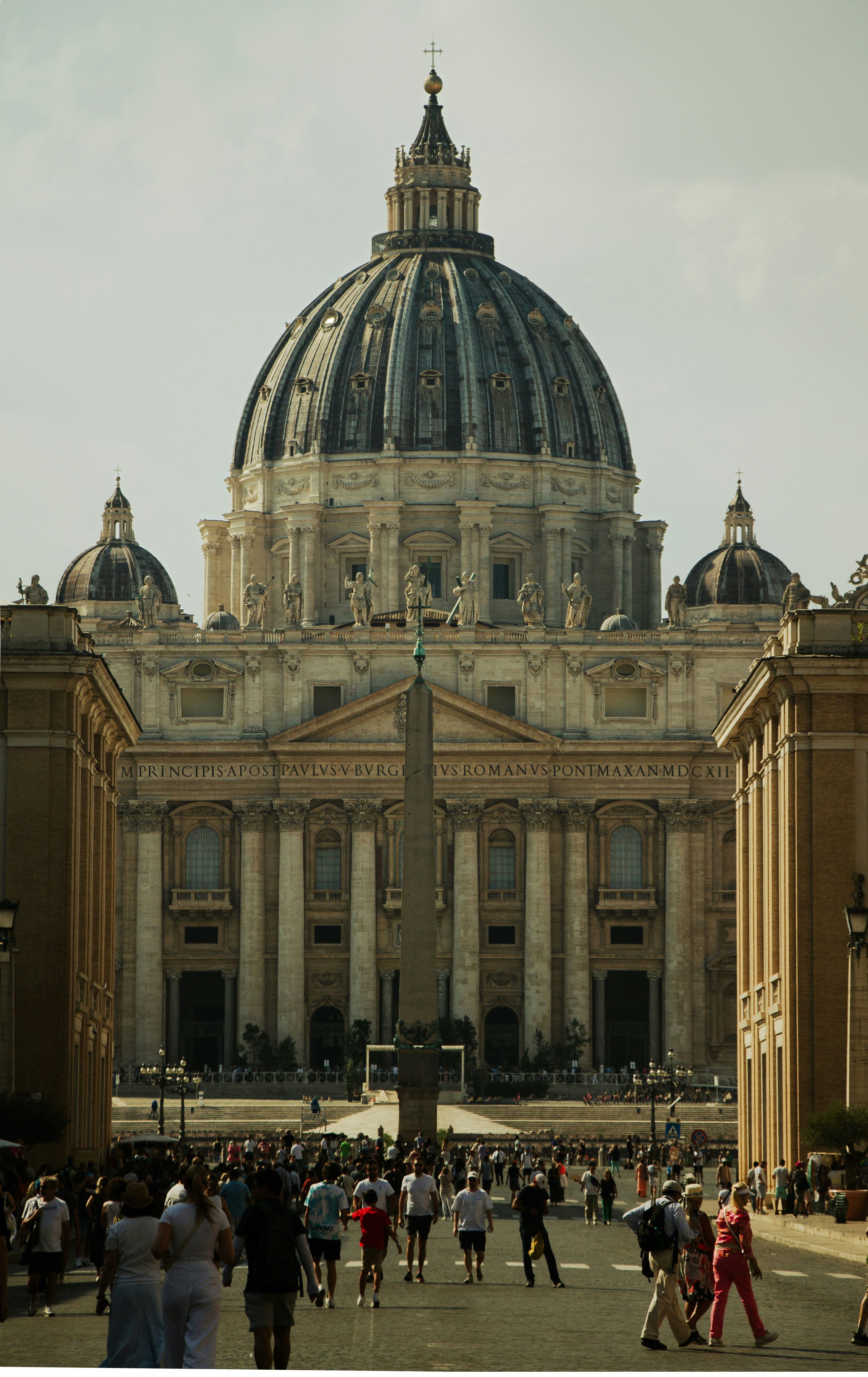 a group of people walking in front of a large building