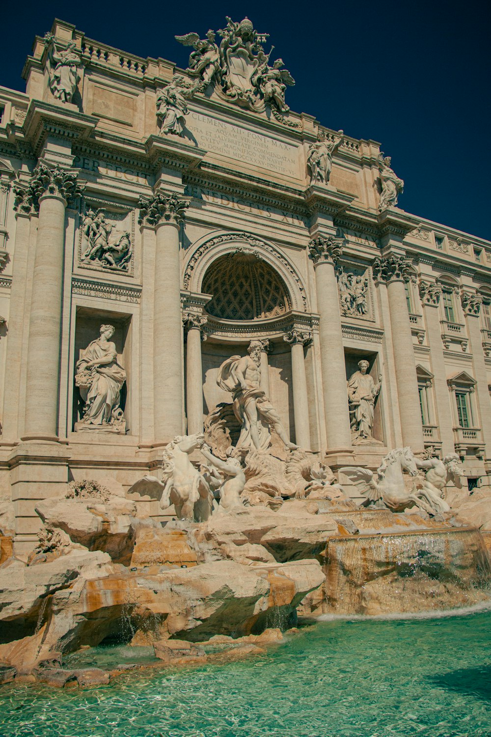 a large building with a fountain in front of it