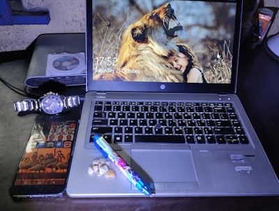 A sleek digital mockup showing lion.tattoo on a laptop screen.