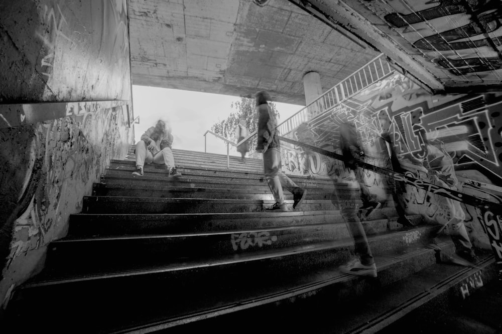 a black and white photo of a person riding a skateboard down a flight of