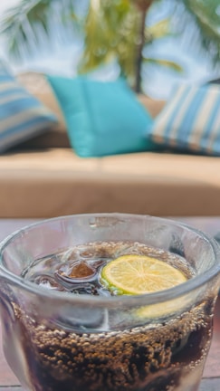 A close-up of a refreshing dirty soda with ice and garnishes.