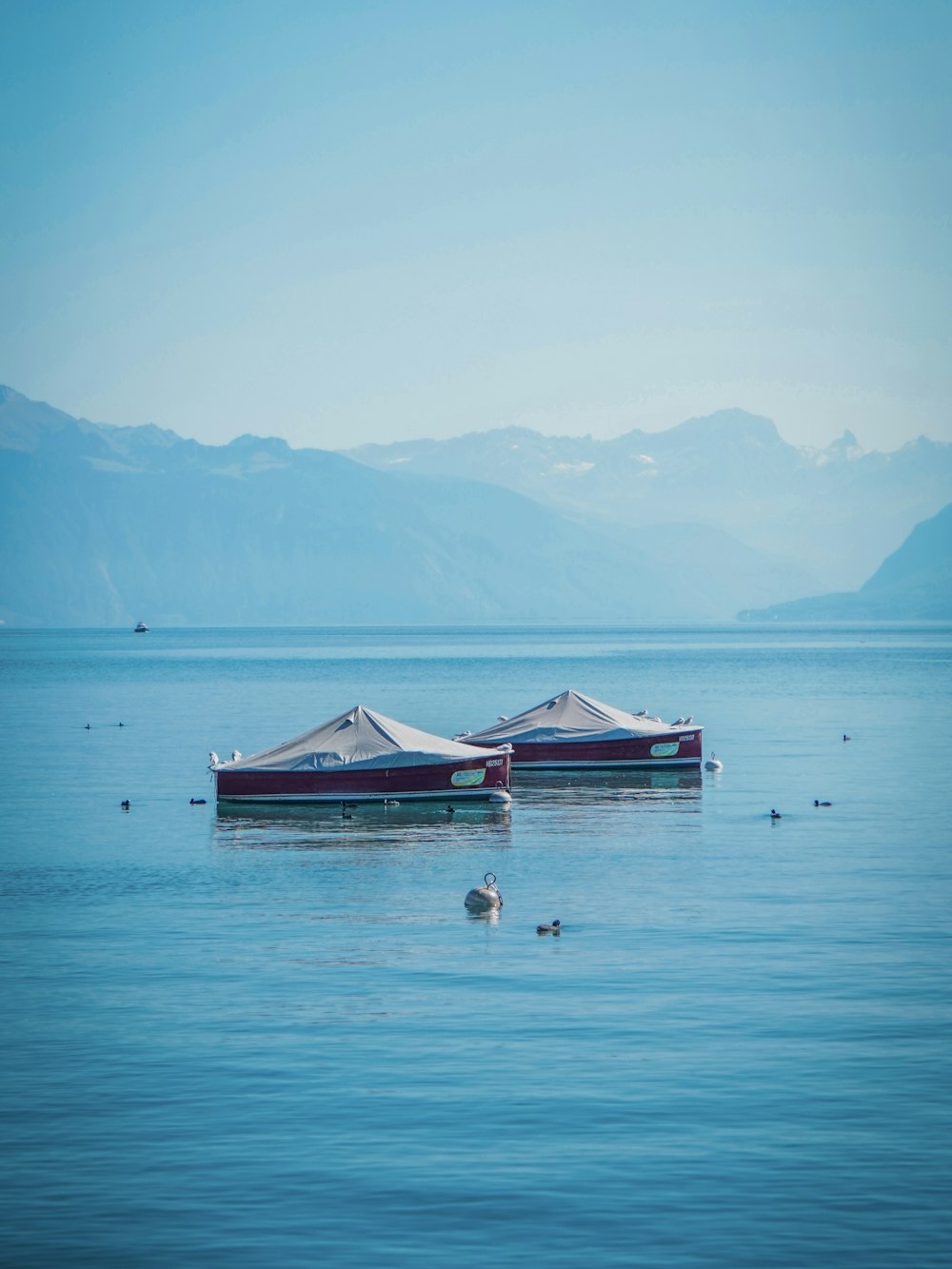 a couple of boats floating on top of a large body of water