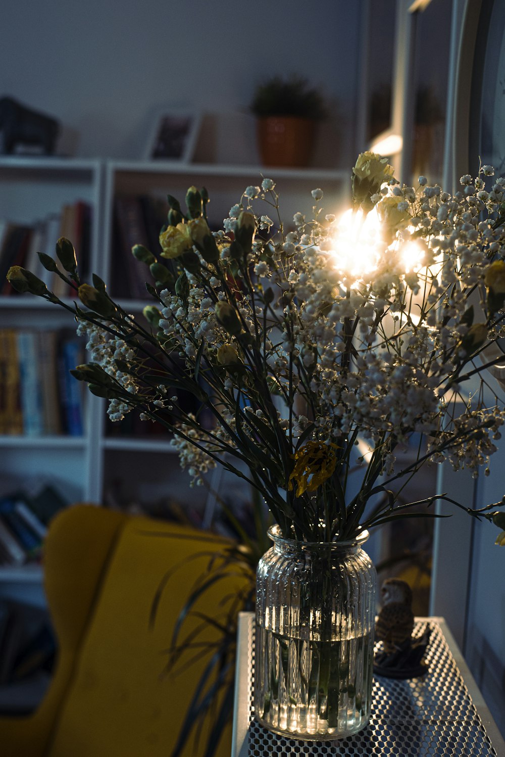 a vase filled with flowers sitting on top of a table