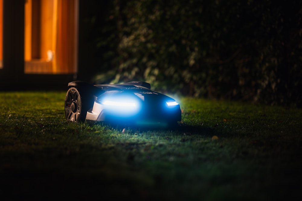 a toy car sitting in the grass at night