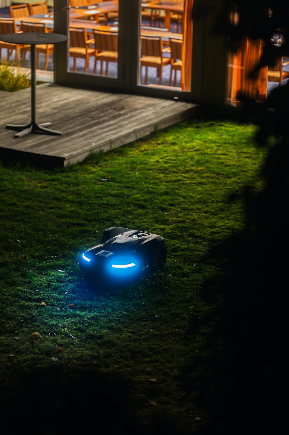 a lawn mower sitting on top of a lush green field