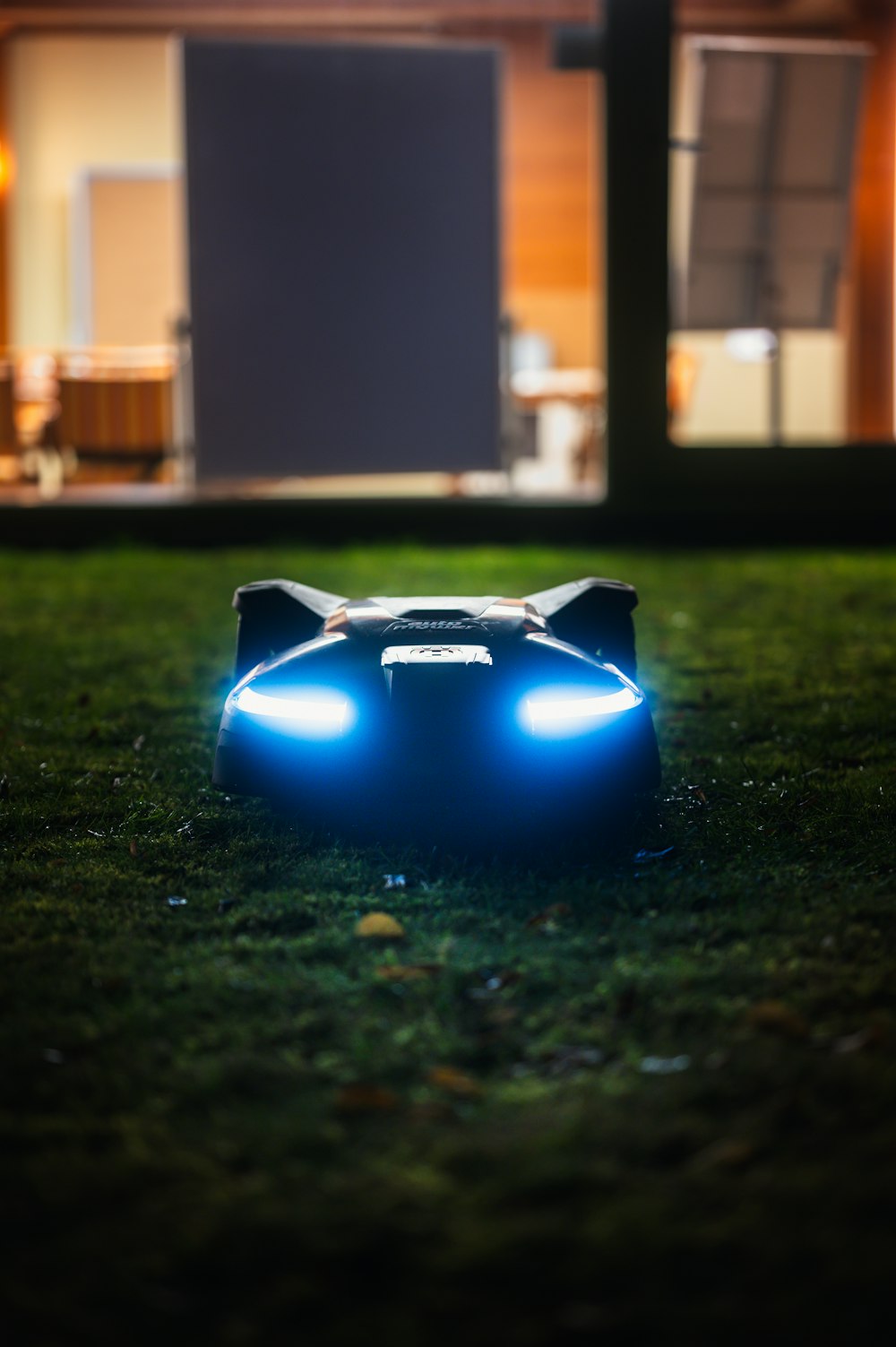 a toy car sitting on top of a lush green field