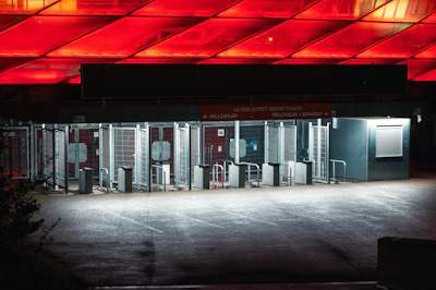 Close-up image of a sleek turnstile system at a corporate entrance with blue lighting accents