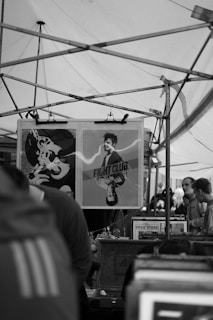 A large outdoor poster featuring a lively market advertisement printed on durable material.