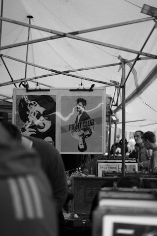 A large outdoor poster featuring a lively market advertisement printed on durable material.