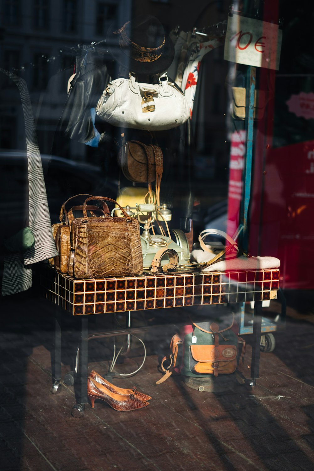 a display of shoes and purses in a store window