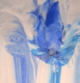 Creative abstract nail art featuring swirls of blue and silver.