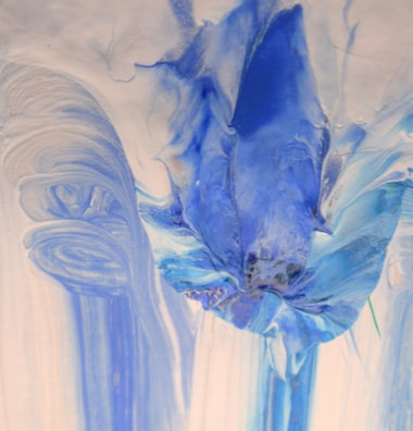 Creative abstract nail art featuring swirls of blue and silver.