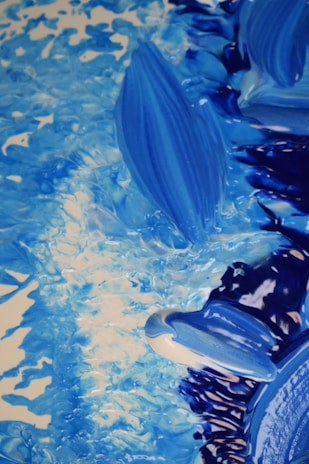 Close-up of a contemplative abstract painting with deep blues and swirling whites capturing an existential mood.