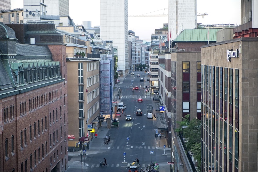 a city street with tall buildings in the background